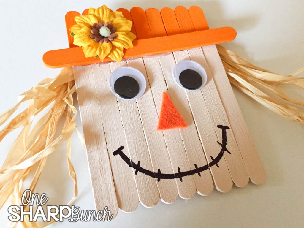 Create this simple fall DIY popsicle stick scarecrow for a super cute fall craft for kids!