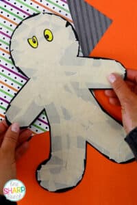 Add this masking tape mummy craft to your list of Halloween party activities! This Halloween craft is a great opportunity to enhance fine motor skills as your students tear and stick masking tape to their FREE mummy template. This mummy craft is perfect for your Halloween centers during your classroom Halloween party in preschool, kindergarten, or first grade. Pair this Halloween craft with your favorite Halloween books this October. Plus, this fall craft makes a cute Halloween bulletin board!