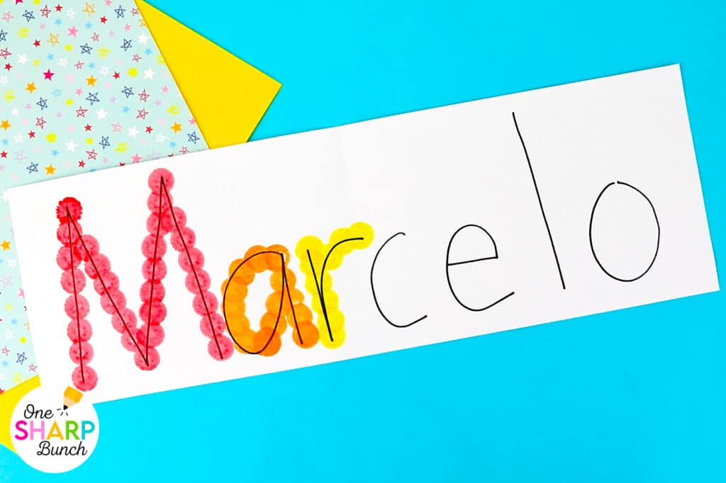 Strengthen fine motor skills while learning names during back to school with this simple bingo dauber name craft! This rainbow name craft is perfect for preschool and kindergarten name activities and name practice activities. Great back to school activities and back to school crafts, it also creates a bright back to school bulletin board. An easy name activity that doubles as engaging fine motor name activities for centers or small groups!